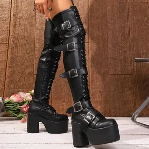 Macro detail of black punk thigh-high boots with thick heels and multi-buckle straps