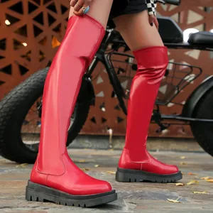 Dettaglio di eleganti stivali sopra il ginocchio rossi con suola platform nera