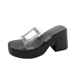 Detailed side view of black platform sandal featuring a rhinestone-embellished clear strap