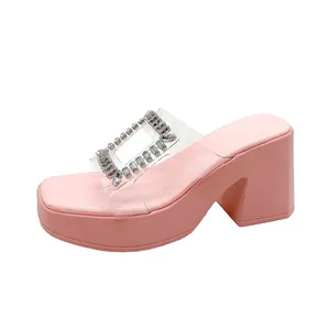 Detail of pink platform sandals with rhinestone square buckle and clear strap.