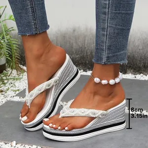 Detail van witte sleehak teenslippers met 8 cm hak en parel accenten