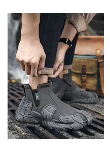 Close-up of grey waterproof high-top men's work boots with side zipper and rugged sole