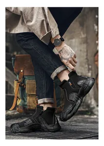 Close-up detail of black waterproof high-top shoes featuring a side zipper