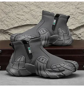 Detail of dark grey high-top men's work boots with chunky anti-slip sole and side zipper.