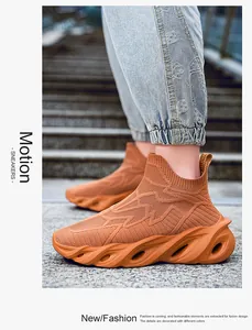 Détail de baskets montantes en maille orange avec semelle ondulée sur des marches