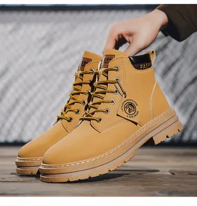 Men's yellow Martin boots with rugged lug sole, brand hangtag, and hiking style design
