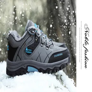 Detailed side view of grey waterproof winter hiking shoes with thick fur lining