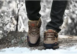 Men's winter hiking shoes with warm fleece lining and non-slip soles on snow.