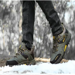 Detail view of men's waterproof fur-lined winter hiking boots on a snow-covered ground