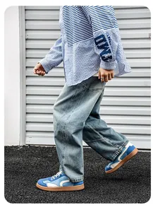 Baskets de style GAT bleues et blanches avec semelle en gomme sur un mannequin homme.