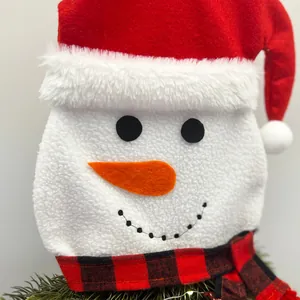 Close-up detail of plush snowman Christmas ornament with red hat and plaid scarf