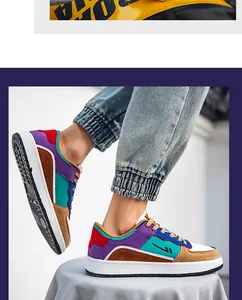 Detailed view of colorful multi-tone men's fashion sneakers in an urban street setting