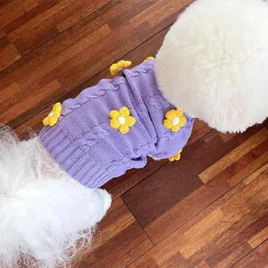Close-up of purple knitted pet sweater with yellow flower details for small dogs