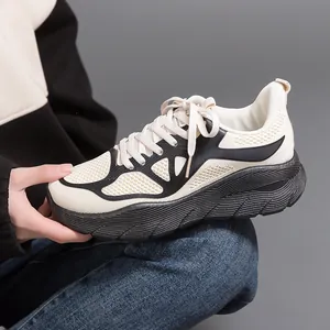 Side view detail of lightweight cream mesh running shoe with thick black soft sole