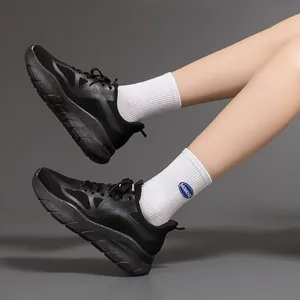Side view of lightweight black athletic sneakers featuring thick shock-absorbing cushioned soles