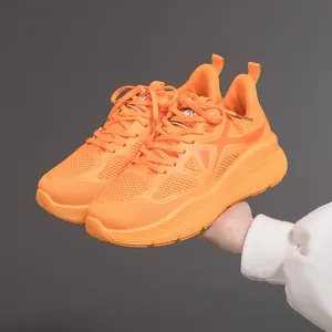 Detailed view of vibrant orange lightweight running shoes with breathable mesh upper