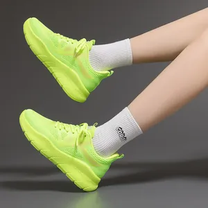 Detail view of lightweight neon green running shoes on feet with white sport socks