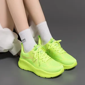 Worn look of neon green running shoes featuring breathable mesh texture and thick soles