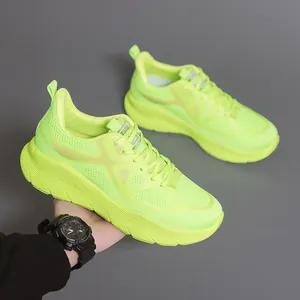 Detailed view of neon green lightweight running shoes with mesh upper and thick sole