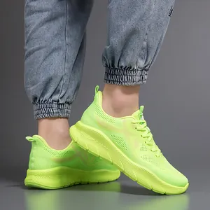Fluorescent green lightweight mesh running shoes with thick cushioned sole detail.