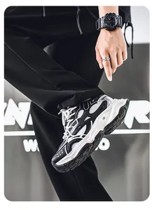 Detailed side view of high-quality black and white retro chunky sneakers for men