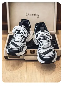 Close-up of black and white retro chunky sneakers on a vintage suitcase