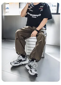 Close-up detail of high-quality silver and grey retro chunky sneakers on male model