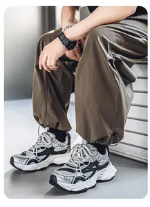 Detail view of men's retro silver chunky sneakers with mesh upper and thick white sole