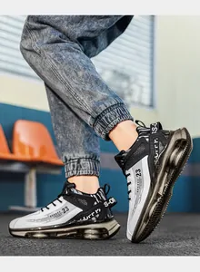 Close-up of white and black high-top basketball shoes with visible air cushion sole