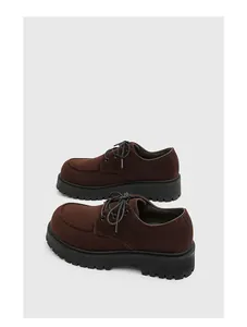 Scarpe Derby retrò marrone scuro con suole spesse e dettagli in pelle scamosciata.
