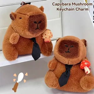 Detail van twee schattige capibara pluche sleutelhangers met stropdassen en paddenstoelen