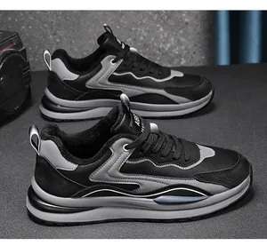 Detailed side view of black and grey casual work sneakers with durable leather surface