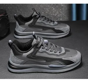 Detail view of grey and black men's casual work sneakers with leather and suede mix.