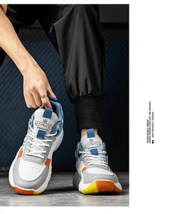 Stylish high-top basketball shoes in white and orange worn by male model in a casual setting