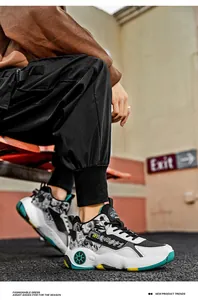 Detailed view of stylish men's high-top basketball sneakers in an urban street setting