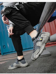 Detailed side view of grey breathable fly-knit men's sock sneakers with thick soles.