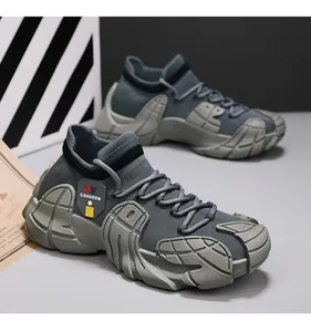 Detailed side view of dark grey fly-woven knit sneakers featuring a textured chunky sole