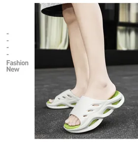 Detailed view of men wearing stylish white and green platform slides for summer outdoor