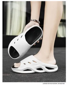 Detailed view of white thick-soled men's foam slide sandals with unique hollow design