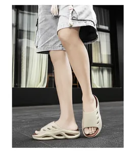 Close-up of men's beige slides with breathable hollow thick sole for summer.