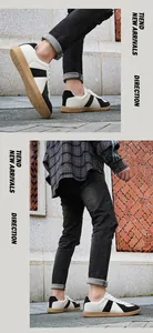 Detailed view of large size men's leather German Army Trainers in beige and black colorway
