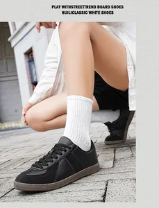 Close-up view of black leather German Army Trainers for men on street background