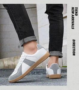Detailed side profile of men's leather German Army Trainers in white and grey suede.