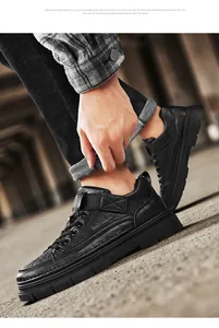 Detailed shot of black non-slip waterproof leather work shoes with thick durable soles
