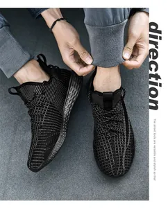 Primo piano di sneakers in mesh nero da uomo indossate con pantaloni sportivi