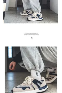 Detailed view of trendy men's chunky beige sneakers with blue accents and thick soles
