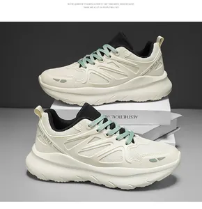 Detailed view of off-white chunky sneakers with mint green laces and platform soles.