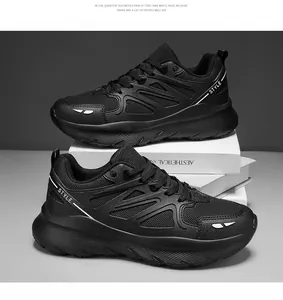 Detail view of black breathable chunky sneakers for men and women on white decorative books.