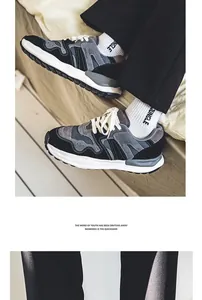 Detailed shot of retro chunky sneakers in black and grey mesh worn with white socks