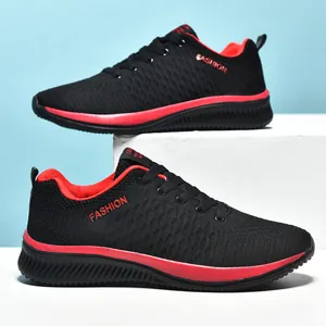 Side detail of breathable fly-knit sneakers in black and red with lace-up design.